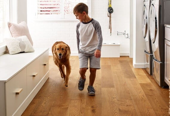 Kid running with dog | Big Bob's Flooring Outlet Winter Garden